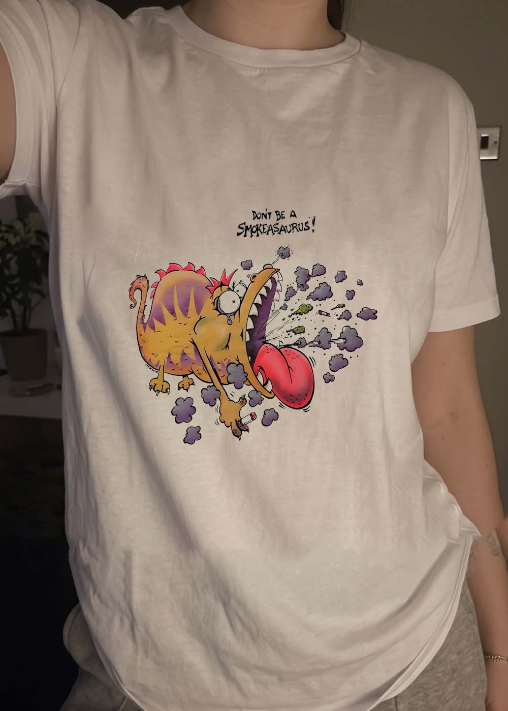 Buttoutz Don’t Be a Smokeasaurus Smoking Dinosaur Cartoon T-Shirt